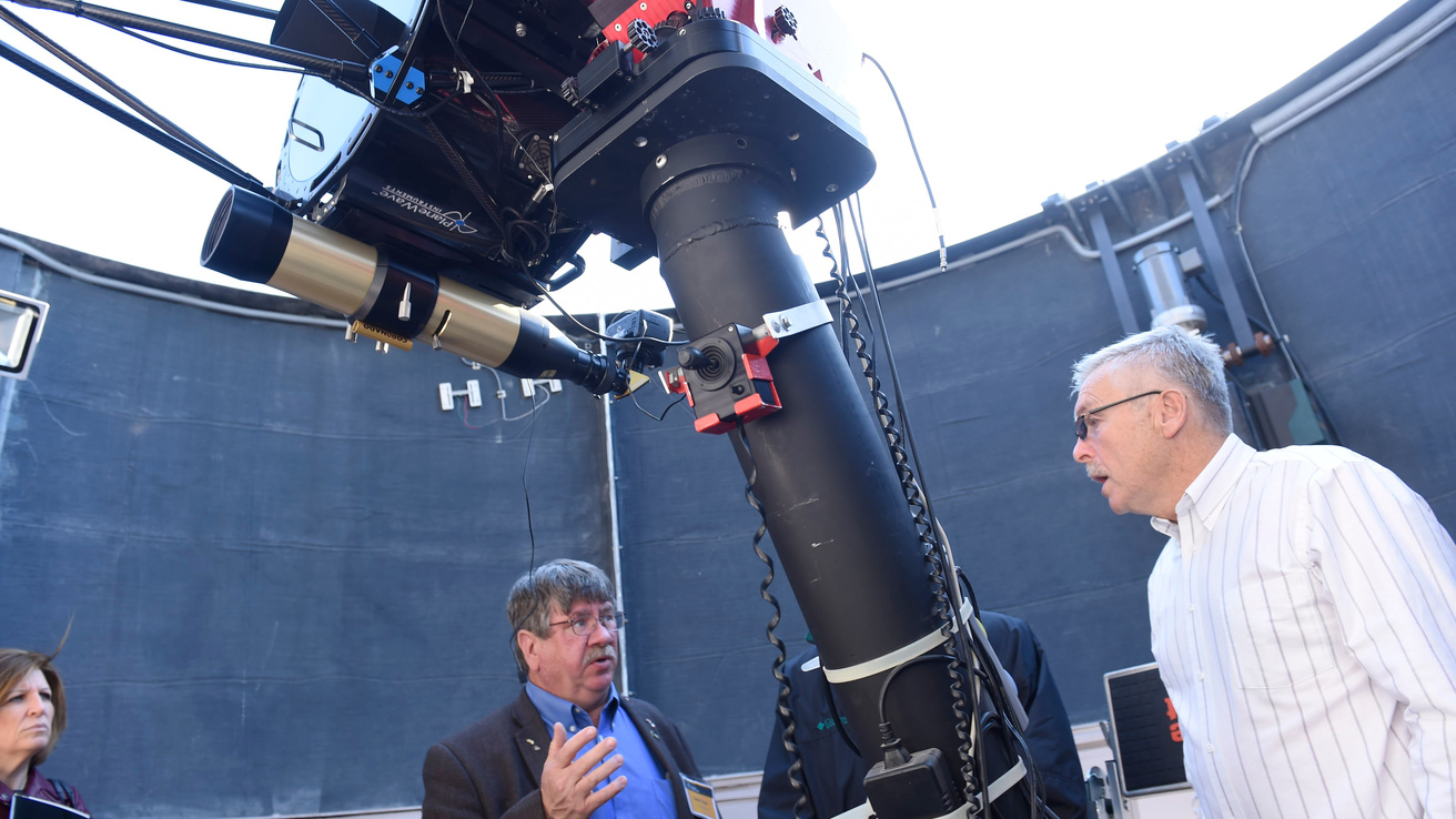 Emeritus Professor Robert Mutel tours guests through the observatory.